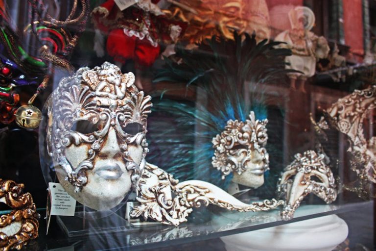 Colección de diferentes tipos de máscaras venecianas artesanales colgadas en pared